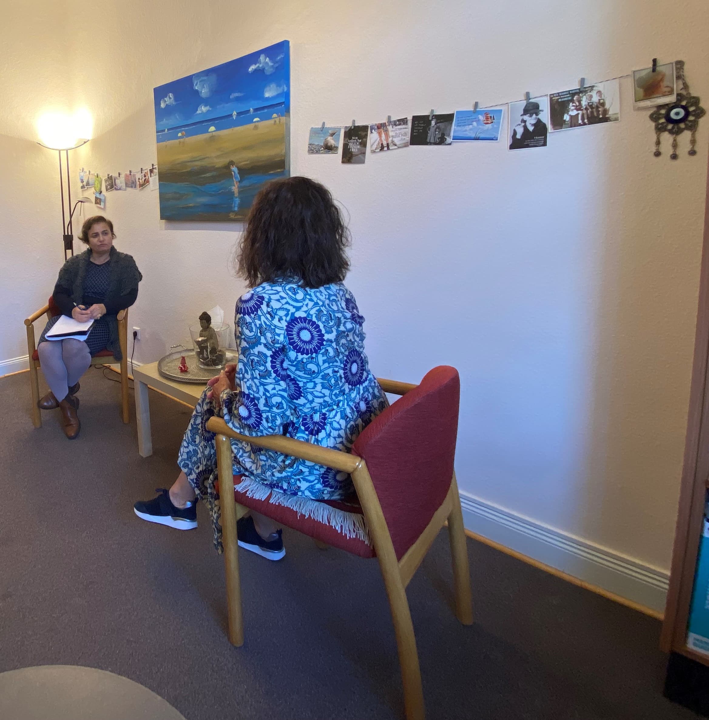 Two people sitting on chairs and talking